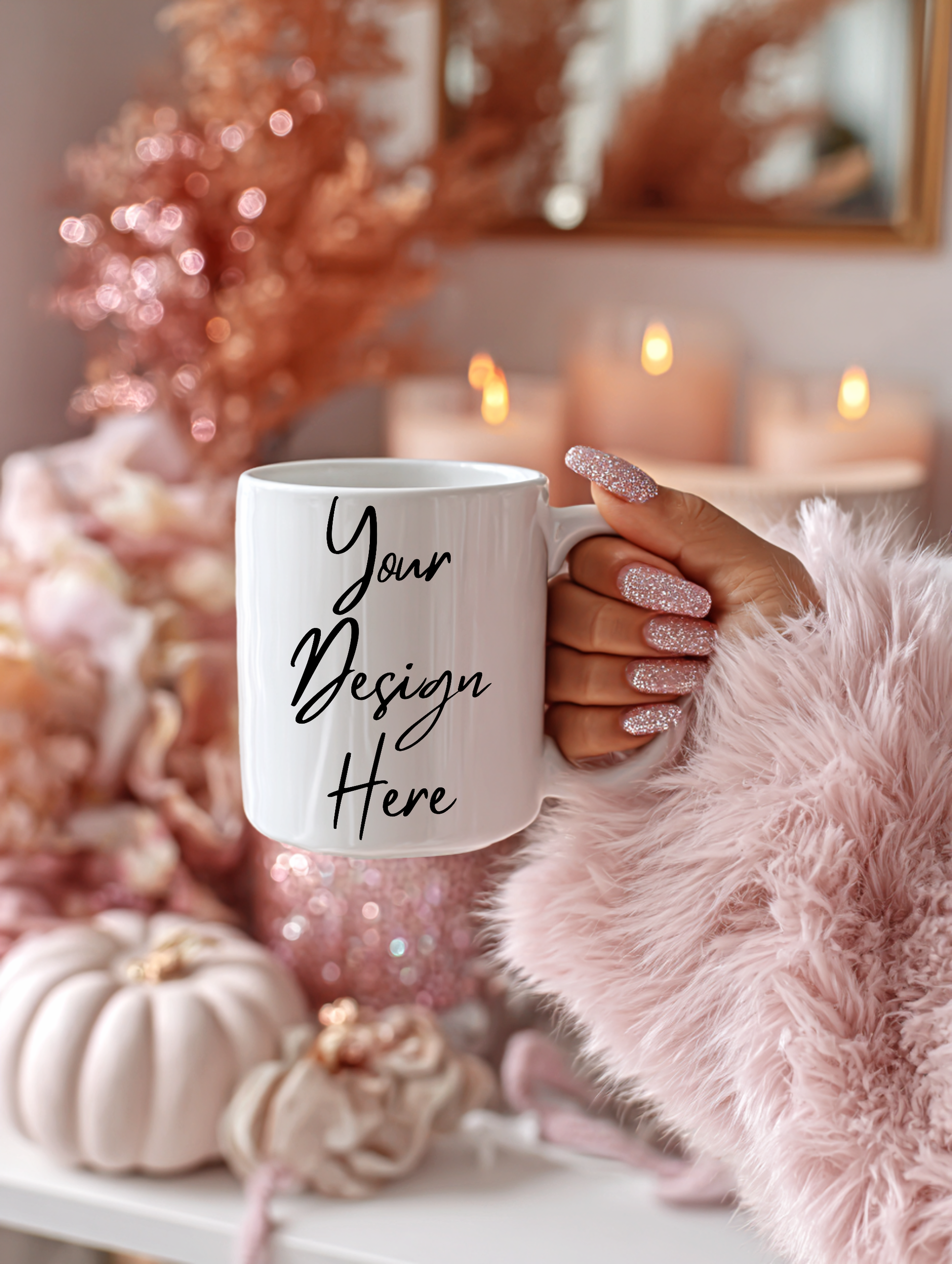 White mug with 'Your Design Here' text held by a hand against a festive background with candles and pumpkins.