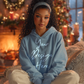 Cozy Christmas hoodie mockup in baby blue color, 300 DPI PSD and PNG for print-on-demand designs, premium lifestyle photo.