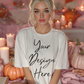 Feminine lifestyle T-shirt mockup with cozy autumn pink decor, pumpkins and candlelight. High-end 300 DPI PSD and PNG mockup for Print-on-Demand apparel design.